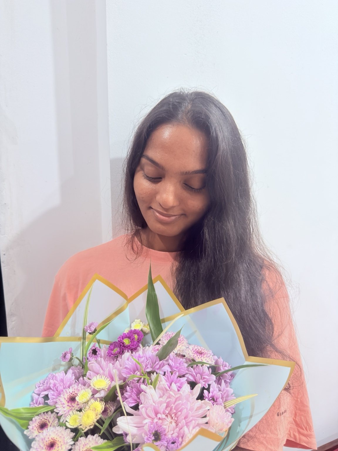 Muthu smiling with flowers