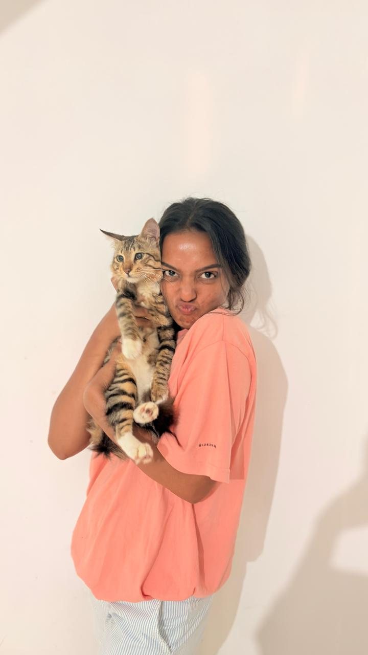 Muthu holding a cat